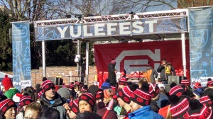 Party people and the the Yulefest sign.