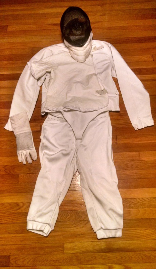 White fencing uniform, black mask, glove.