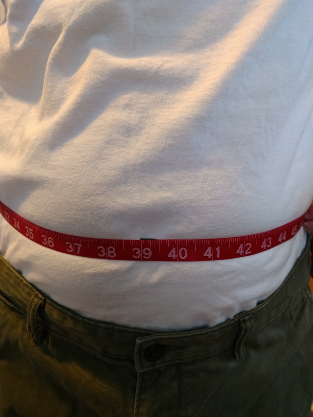 Measuring tape around a person wearing a tee shirt. 